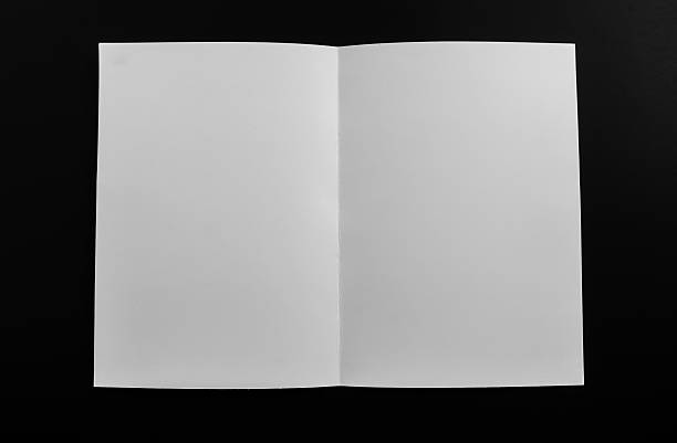 Folded blank paper on black background stock photo