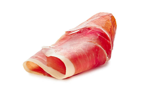 Folded jamon of ham slice on white Folded jamon of ham slice isolated on white background prosciutto stock pictures, royalty-free photos & images