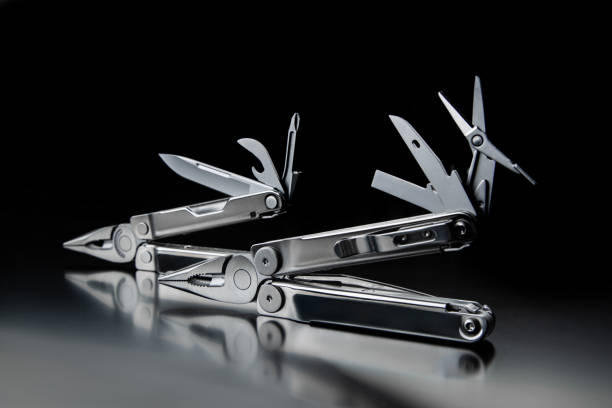 Folding multitools on a dark background. Metal pocket multi-tools. stock photo