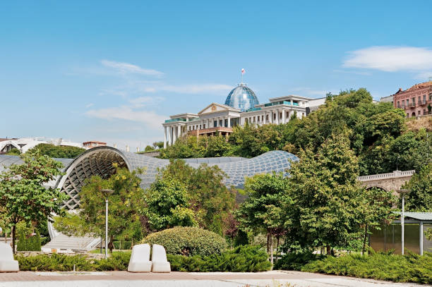 Foliage of Rike park and president palace at background in Tbilisi, Georgia stock photo