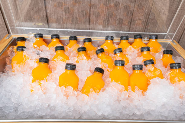 food and drink, orange juice in a bottle with ice stock photo
