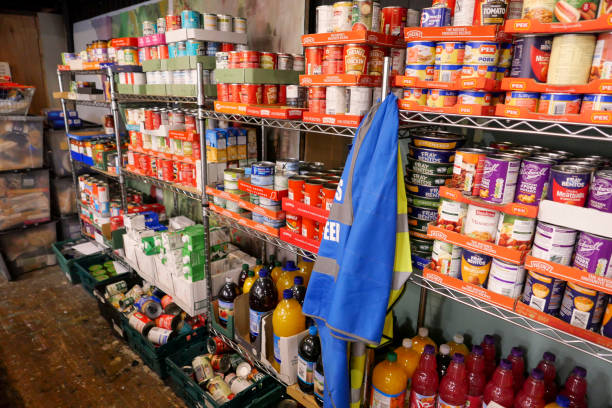 Food bank shelving filled with donated tinned food ready for distribution 7th August 2020: Shelves filled with donated food, ready for distribution at a charity food bank centre in the town of Penicuik in Midlothian, Scotland, where emergency food parcels are given to those in crisis. A problem that has increased since the Covid-19 pandemic, with more people losing jobs and getting into financial difficulty. food bank stock pictures, royalty-free photos & images