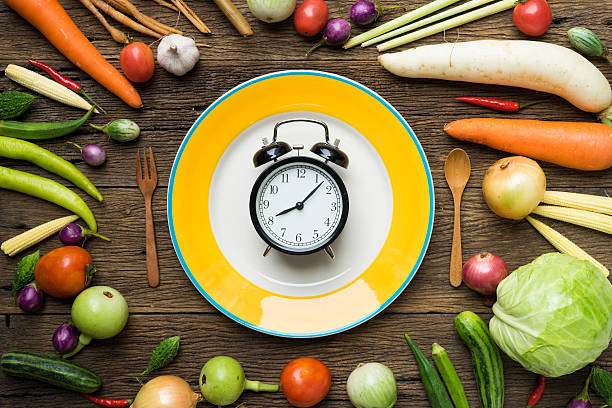 Food clock. Healthy food concept on wooden table stock photo