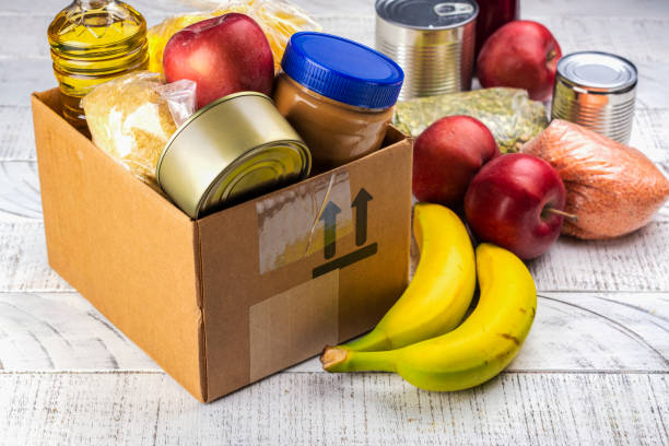 Food donation box Food sharing concept. Fighting with overconsumption background. Various products in a food donation box food donation stock pictures, royalty-free photos & images