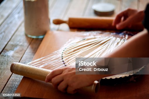 istock Food preserving using plastic wrap, close up 1058013350