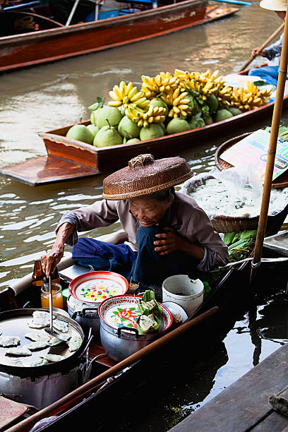Food vendor at Damnoen Saduak Floating Market, Thailand stock photo