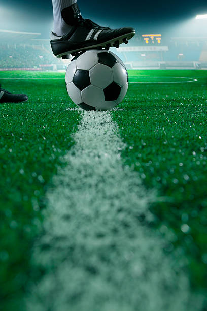 Foot on top of soccer ball stock photo