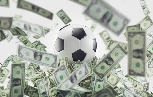Football ball with money, soccer business stock photo