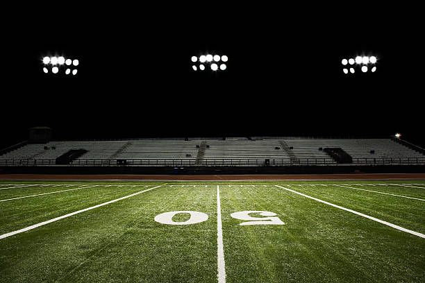 Football Field at Night  american football field stadium stock pictures, royalty-free photos & images