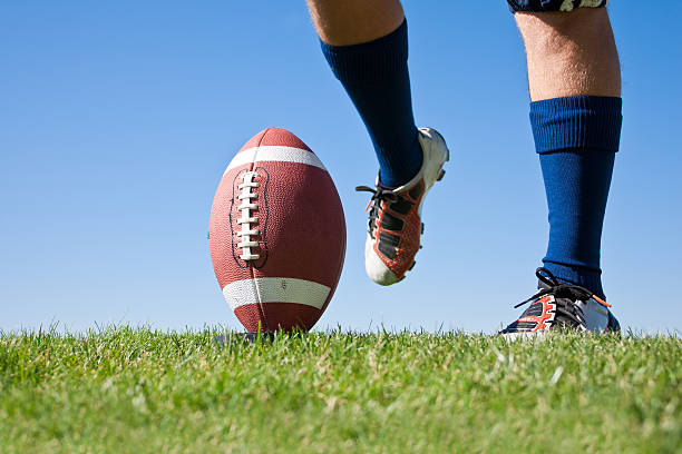 Football Kickoff American Football Kickoff close-up photo. Athlete ready to kick the ball. Horizontal with lots of Copy Space kicking stock pictures, royalty-free photos & images