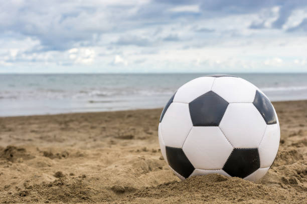 football on deserted beach - futebol de praia imagens e fotografias de stock