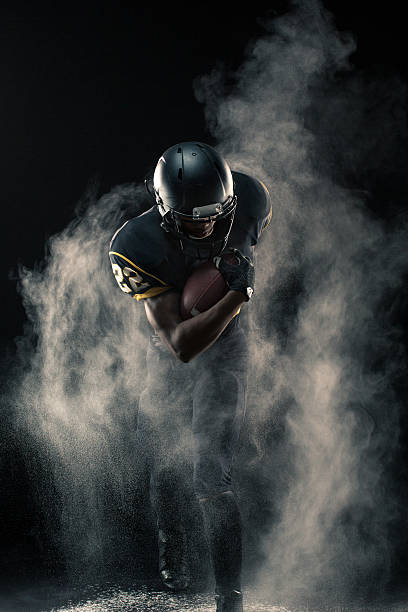 Football Player Young African American football player. american football player stock pictures, royalty-free photos & images