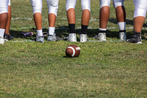 Football players ready for the game Football placed on field – Players getting ready for the game high school stock pictures, royalty-free photos & images