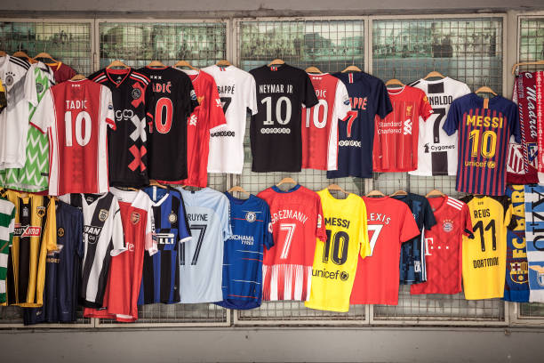 Football Soccer jersey t-shirts, belonging to the main european UEFA Champions league competition, for sale in a shop of Belgrade, hanging. Picture of t-Shirt, European Football Soccer jerseys, on display in a shop of Belgrade, Serbia. uefa champions league stock pictures, royalty-free photos & images