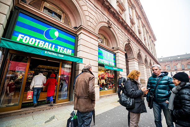 Football Team Store in Milan, Italy Milan, Italy - December 20, 2014: Football Team Store in Milan, Italy. People entering the store, Another group of people talking on the street. soccer store stock pictures, royalty-free photos & images