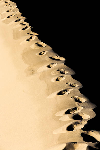 Footprints on sand dune stock photo