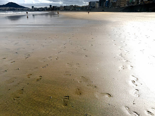 Footprints on the sand stock photo