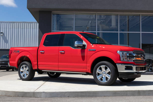 Ford F150 display at a dealership. The Ford F-150 is available in XL, XLT, Lariat, King Ranch, Platinum, and Limited models. stock photo