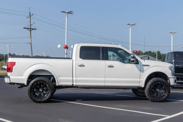 Ford F-150 display at a dealership. The Ford F150 is available in XL, XLT, Lariat, King Ranch, Platinum, and Limited models. stock photo