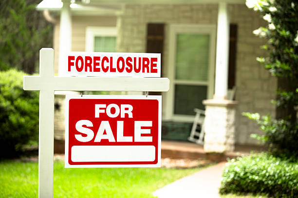 Foreclosure, house for sale sign. Front yard of home. Nobody. stock photo