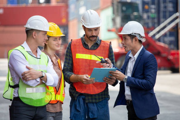 Foreman and secretary clipboard   meeting with worker to checking  control loading Containers box at warehouse logistic in Cargo freight ship for import export in harbor. shipping in docks. stock photo