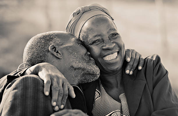 forever loved in love african american couple in their eighties and seventies, hugging and kissing, Botswana old black couple in love stock pictures, royalty-free photos & images