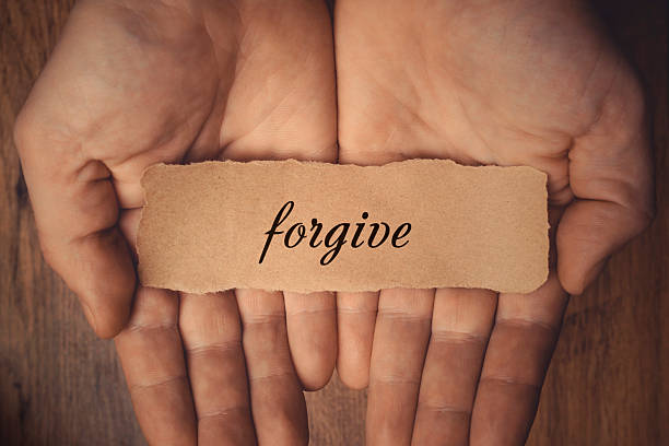 Forgive Hands holding piece of paper with word Forgive forgiveness stock pictures, royalty-free photos & images