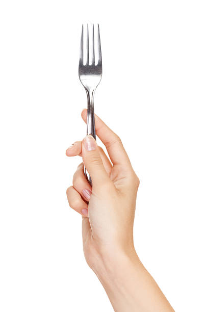 Fork in hand isolated on white background stock photo