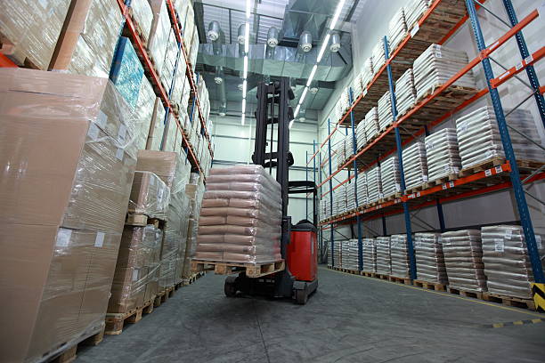 Forklift loader with pallet of sacks in distribution warehouse stock photo