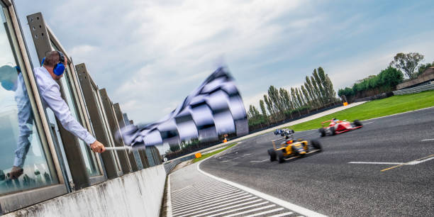 Formula race cars speeding towards the finish line stock photo