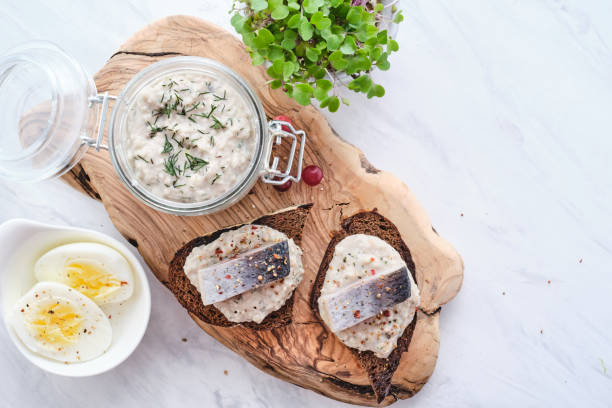 Forshmak - traditional Jewish cuisine. Sandwich with minced herring fillets with apple, onion and egg. stock photo