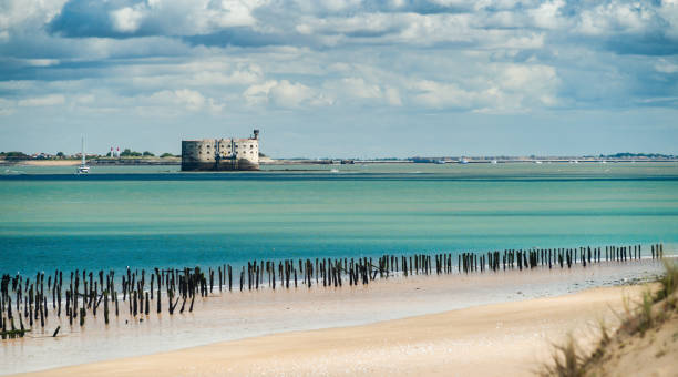Fort Boyard in the Oleron Island during summer with turquoise ocean and scenic clouds Fort Boyard in the Oleron Island during summer with turquoise ocean and scenic clouds fort stock pictures, royalty-free photos & images