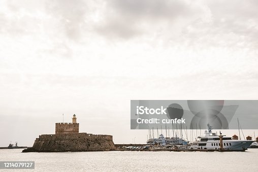 istock Fort of St. Nicholas and Lighthouse in Mandaki Harbor, Rhodes 1214079127