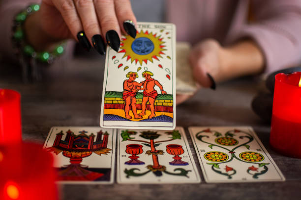 Fortune teller reading a future by tarot cards stock photo