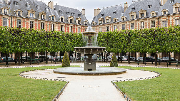 Fountain and grounds of the Place des Vosges stock photo