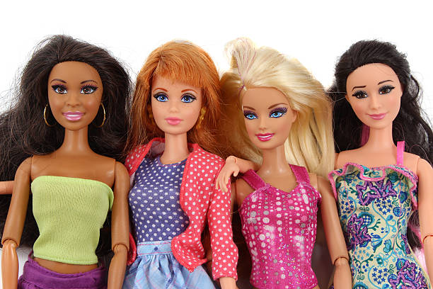 four barbie fashion dolls on white background - barbie stockfoto's en -beelden