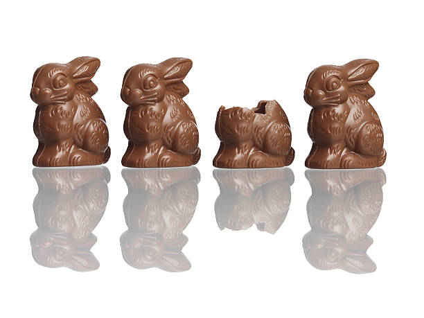 Four chocolate rabbits one eaten stock photo