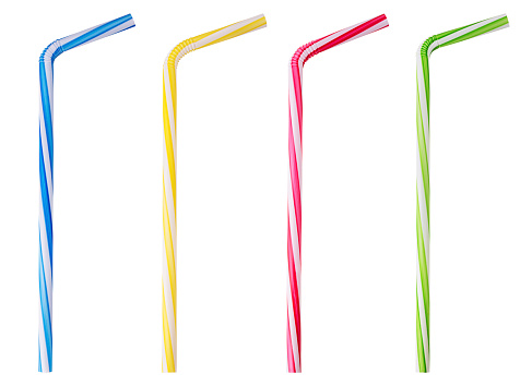 Four drinking straw pink, blue, yellow, green striped isolated on white background. Clipping Path. Full depth of field.