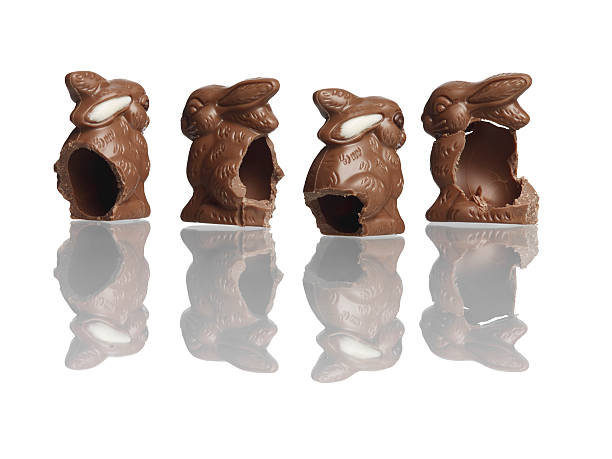 Four eaten chocolate rabbits stock photo