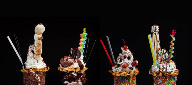 vier freak und verrückte riesenmilchshakes vor schwarzem hintergrund - ice cream fancy stock-fotos und bilder