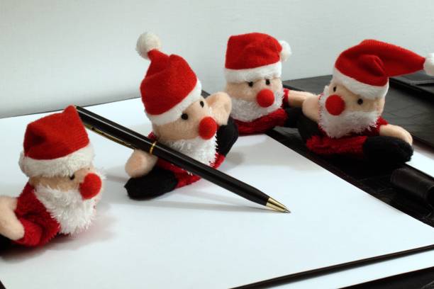 fyra roliga tomteleksaker med kulspetspenna - santa holding magazine bildbanksfoton och bilder
