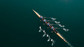 istock Four male athletes sculling on lake in sunshine 861260718