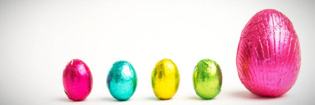Four small easter eggs beside large one  easter sunday stock pictures, royalty-free photos & images