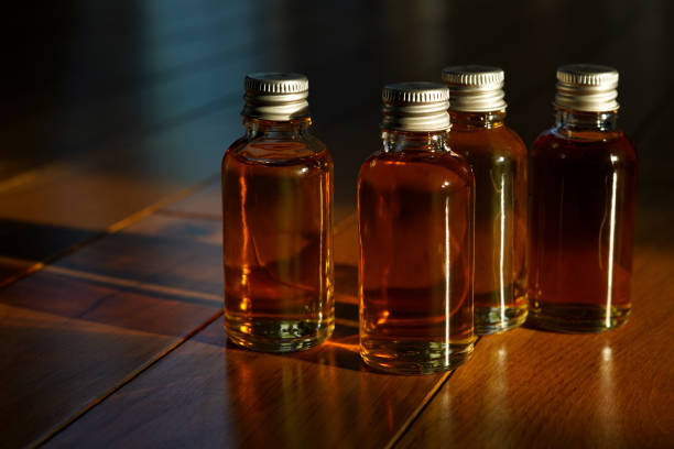Four small glass bottles for a whisky tasting stock photo