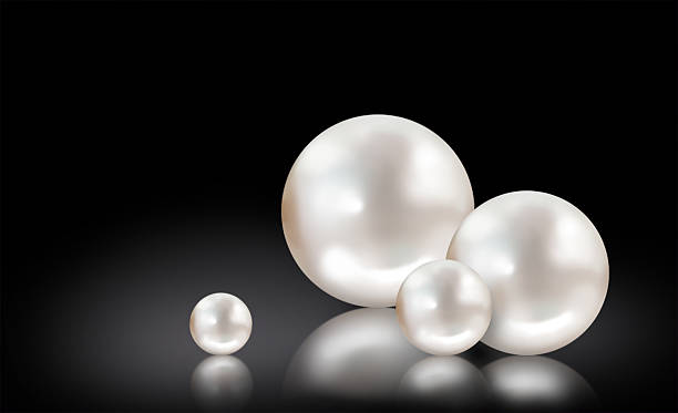 Four white pearls on black background stock photo