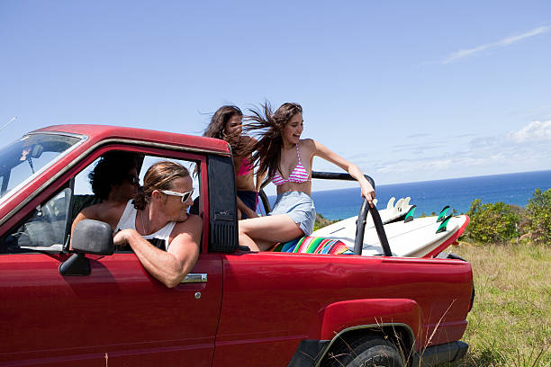 Four young friends driving off road vehicle on vacation  puerto rican women stock pictures, royalty-free photos & images