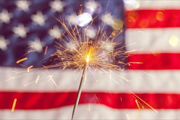 Fourth of july. Sparkler and usa flag showing 4th of july independence day stock pictures, royalty-free photos & images