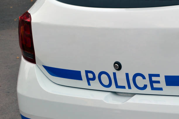 Fragment of a white police car with a blue strip, concept police stock photo