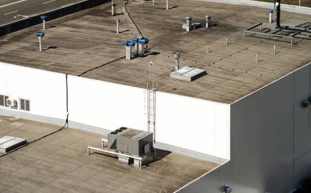 Fragment of the roof of a commercial building with an external unit of the commercial air conditioning and ventilation systems stock photo
