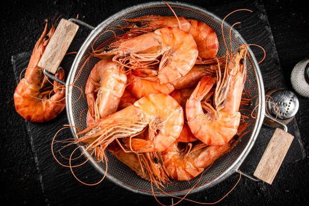 Fragrant boiled shrimp in a colander. stock photo